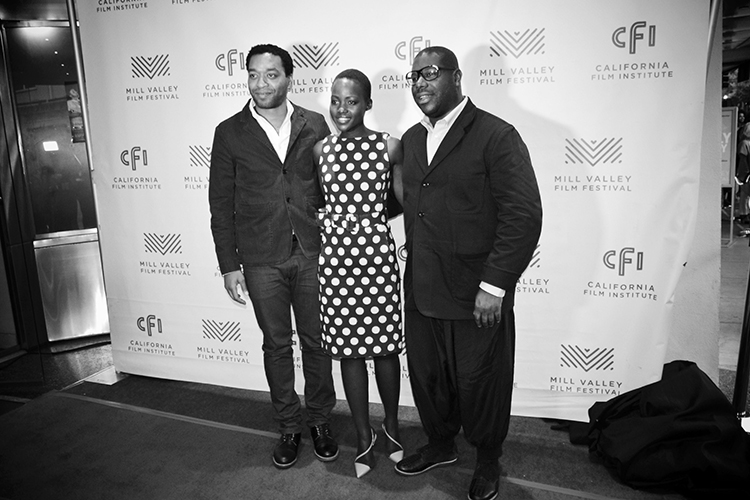 three people posing at a film screening