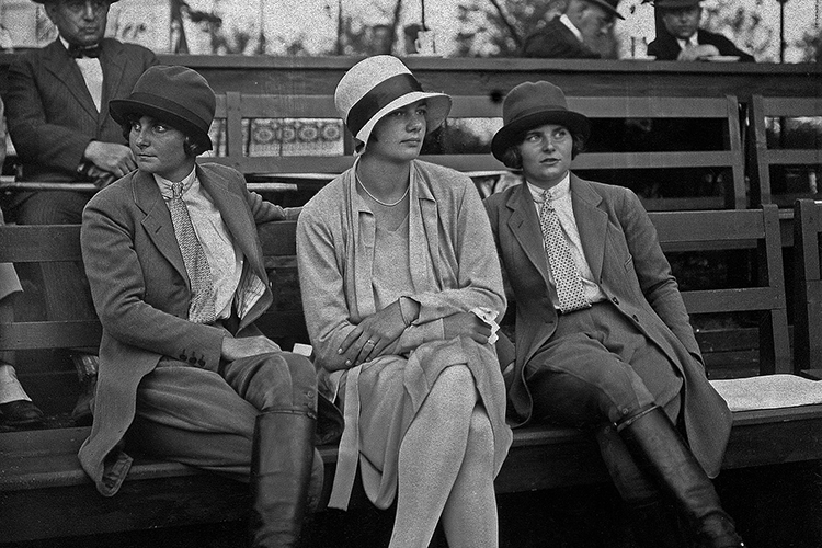 three women sit on a bench in 1928