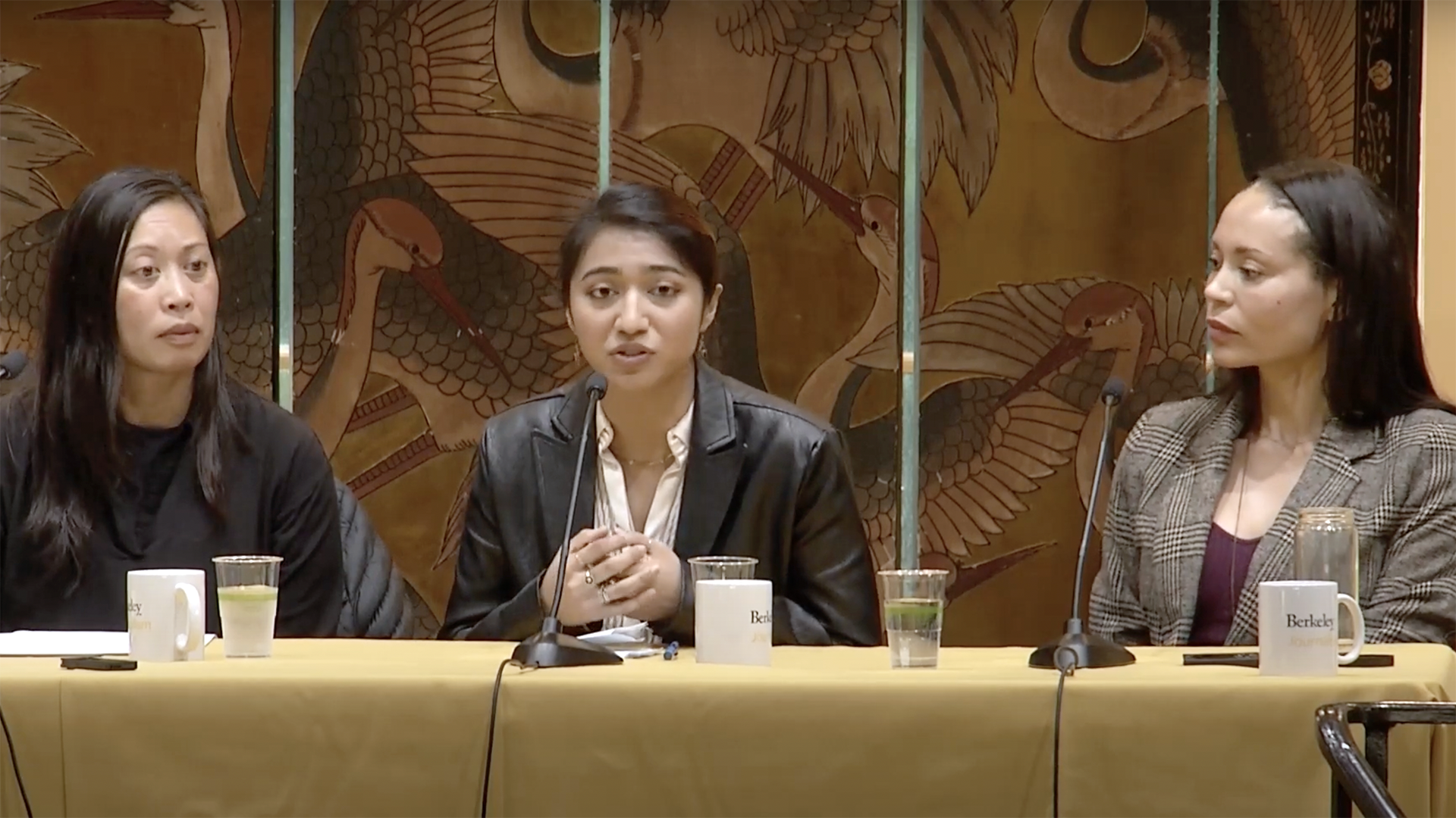 Bernice Yeung, Isabella Gomes and Holly Joshi sit at a long table with microphones in front of them