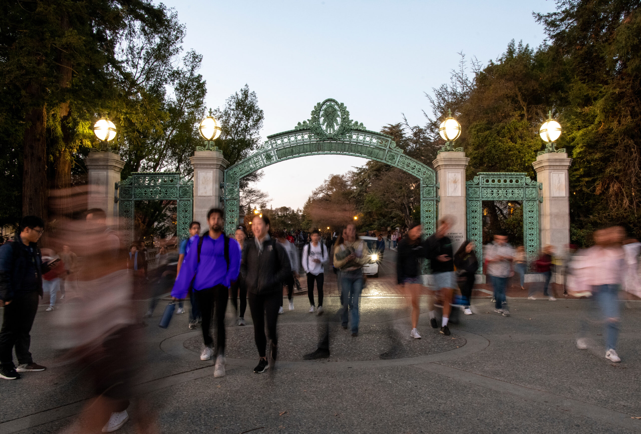 Students pass under Sather Gate on UC Berkeley's campus.