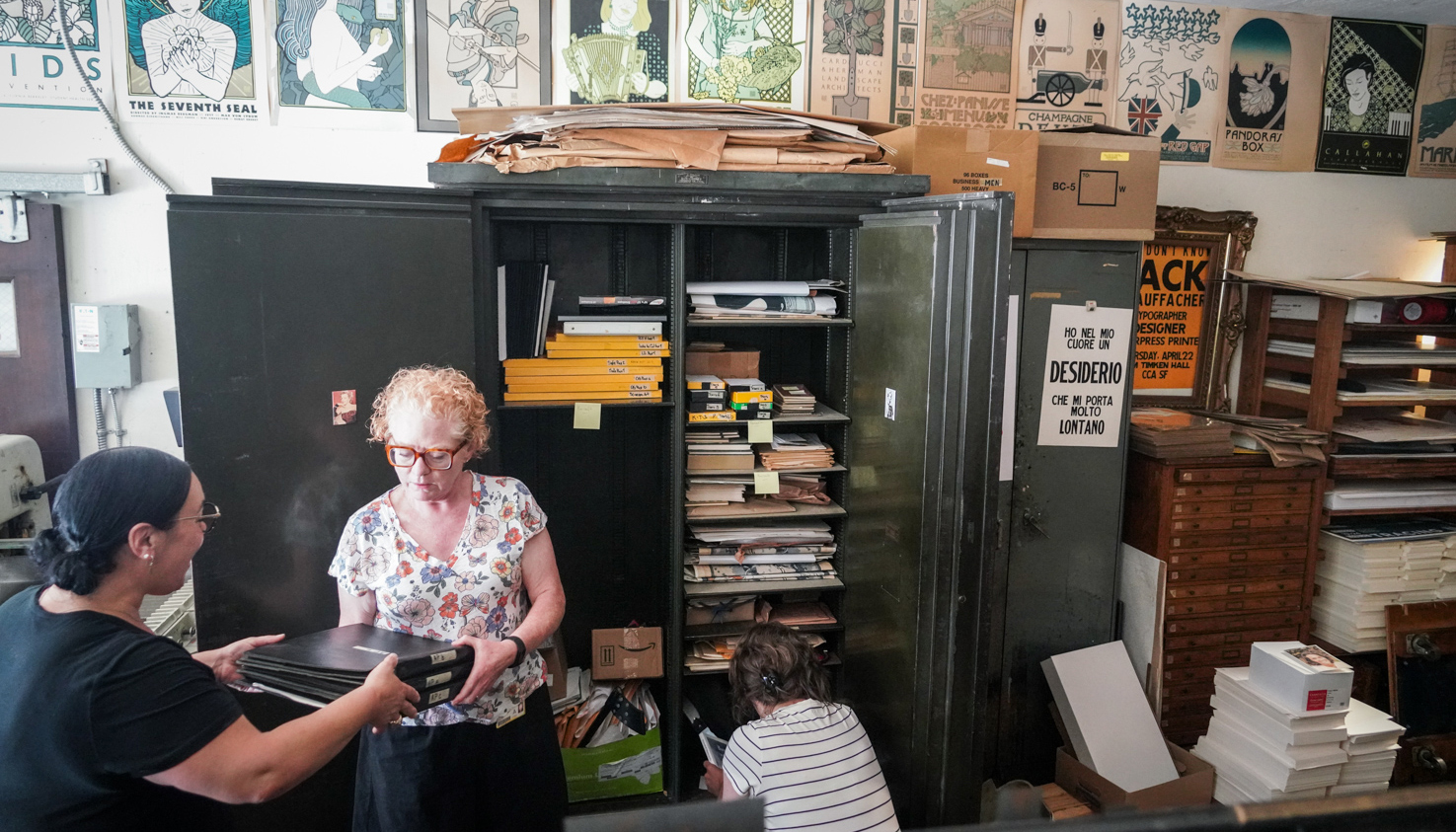 Hannah Hoffman hands items to Lara Michels of Bancroft Library at St. Hieronymus Press