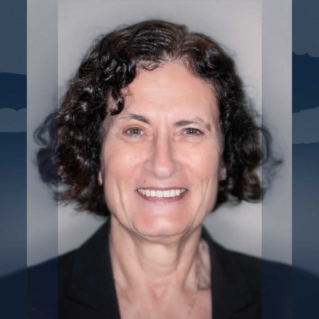 woman with dark hair smiling at camera