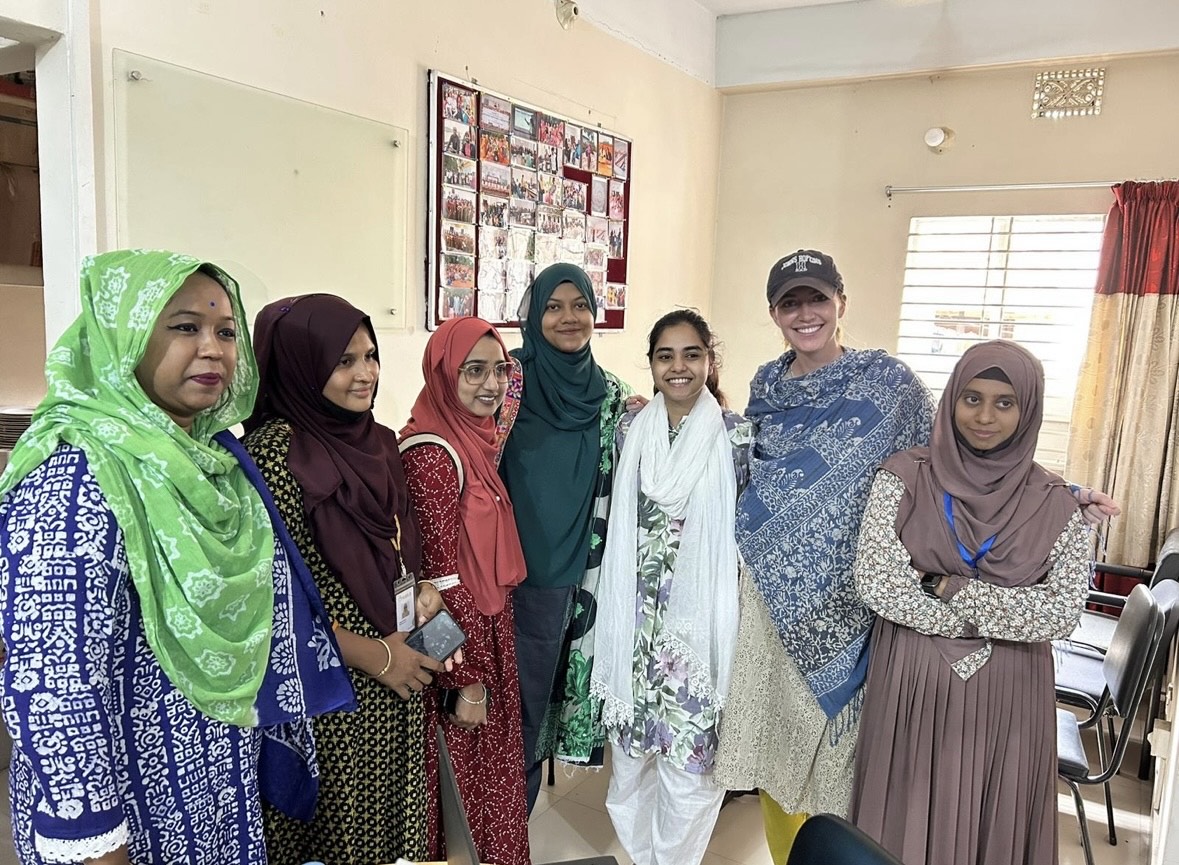 A group of seven people pose for a photo that was taken during Cara Schulte's research in Bangladesh