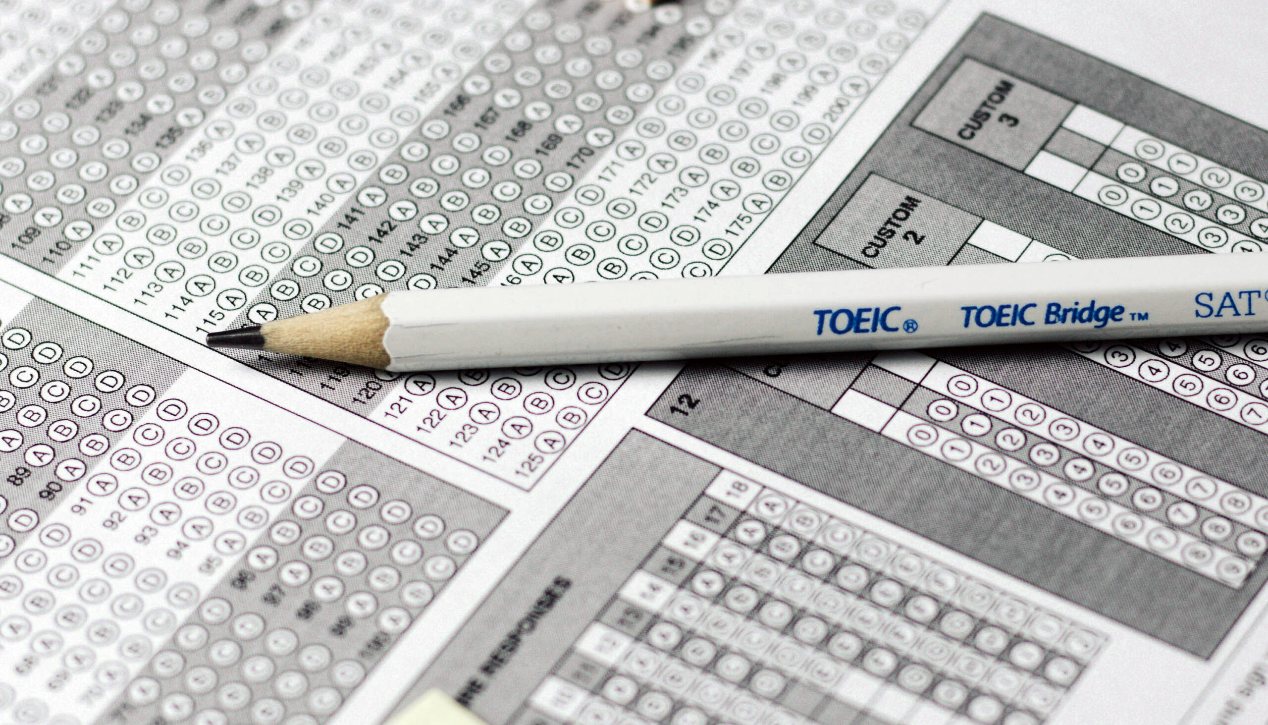 a sharpened pencil laid across the page of a standardized test